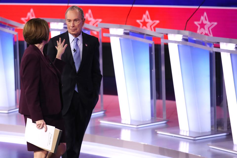 Democratic presidential candidate Sen. Amy Klobuchar (D-MN) and former New York City Mayor Mike Bloomberg speak after the Democratic presidential primary debate.