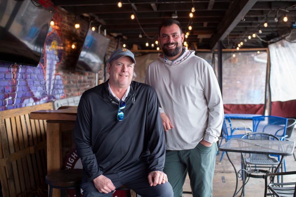 Thad Cox Jr., left, and Michael Saporito II pose at what they will soon reopen as Ashe's Bearden Beer Market in the Bearden Village neighborhood of Knoxville. The "Ashe's" name was attached to the business under new ownership, which includes Cox, who has built a reputation under the name as owner of the neighboring Ashe's Wines & Spirits since 1990.