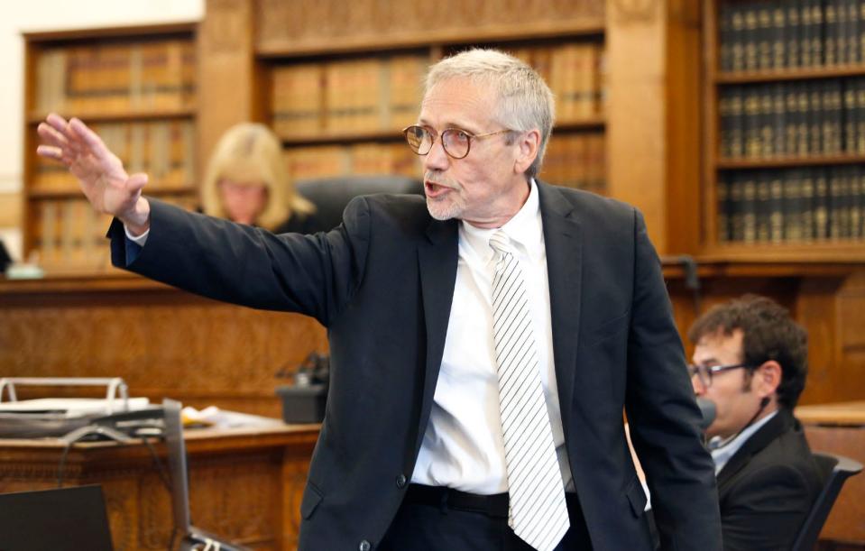 Defense lawyer Larry Lipton gestures toward his client, Emanuel Lopes, during Lipton's opening statement in Norfolk County Superior Court in Dedham on Thursday, June 8, 2023. Lopes is accused of murdering Weymouth police Sgt. Michael Chesna and Vera Adams in 2018.