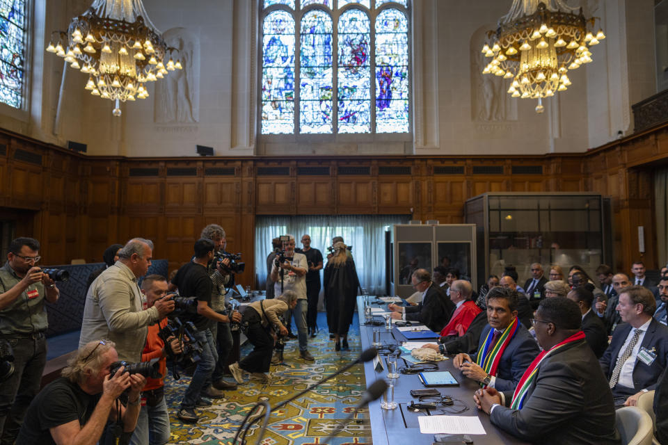Members of the media take images of South Africa's delegation, front right, at the International Court of Justice, in The Hague, Netherlands, Thursday, May 16, 2024. The U.N.'s top court opened two days of hearings in a case brought by South Africa to see whether Israel needs to take additional measures to alleviate the suffering in war-ravaged Gaza. (AP Photo/Peter Dejong)