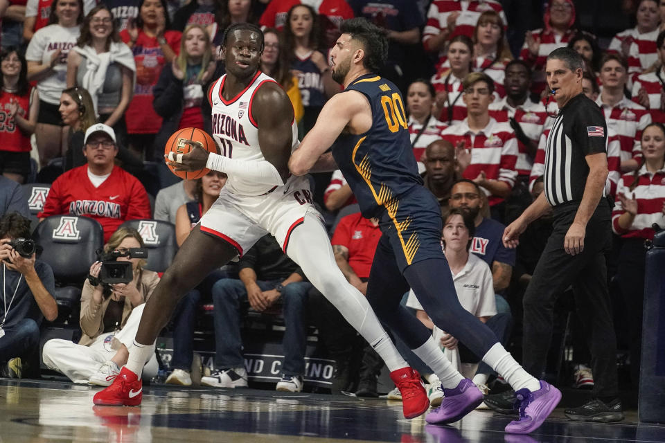 California's Fardaws Aimaq, right, guards Arizona's Oumar Ballo during the first half of an NCAA college basketball game Thursday, Feb. 1, 2024, in Tucson, Ariz. (AP Photo/Darryl Webb)