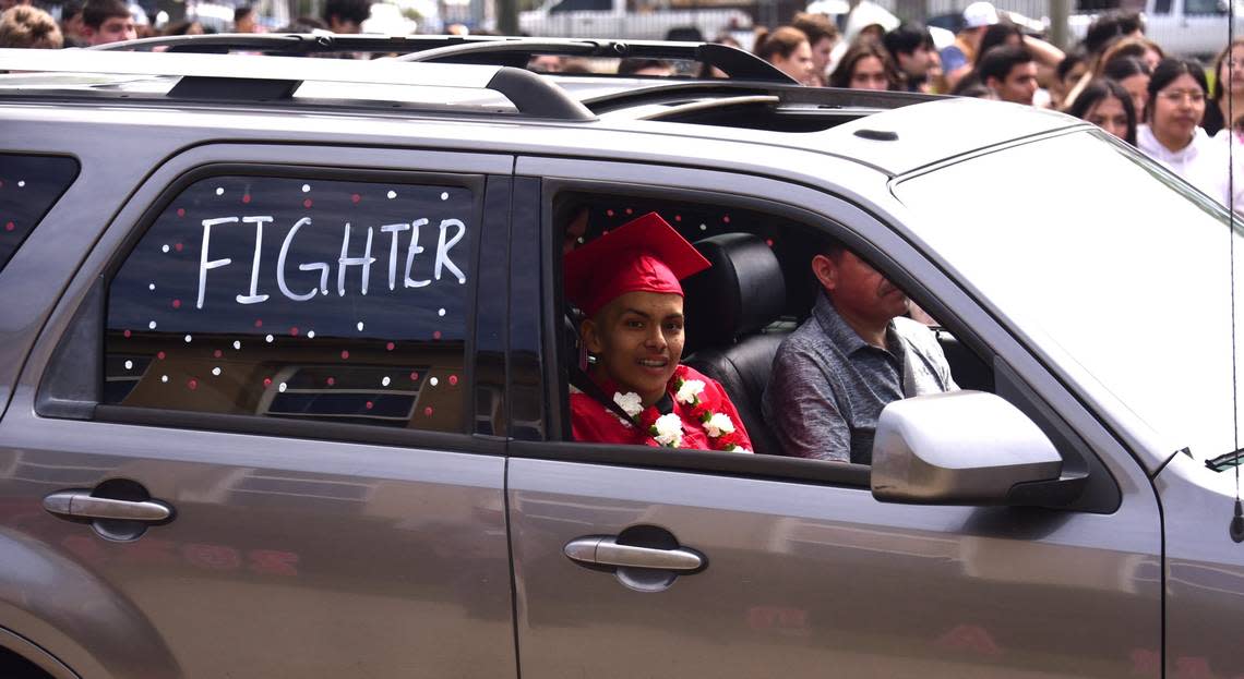 Gustine High School senior Brian Ortiz Nunez looks on from his family car during a special graduation ceremony for Ortiz Nunez, who is battling a rare cancer, on Friday, April 12, 2024 in Gustine, Calif.