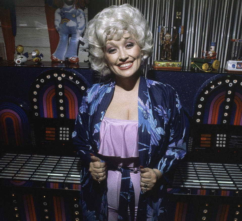 FILE - Singer and actress Dolly Parton attends a party following the premiere of her movie "9 to 5" on Dec. 12, 1980, in Los Angeles. The Grammy-winning legend's 1980's hit song "9 to 5" has been flipped by Squarespace, the company that helps users build and host their own websites, for a Super Bowl commercial debuting Tuesday, Feb. 2, 2021. Oscar winner Damien Chazelle of "La La Land" fame directed the spot. (AP Photo/Harms, File)