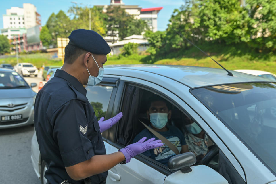 The prime minister also said the number of passengers allowed in vehicles ferrying goods and those part of supply chains will depend on the number permitted as stated on their registration and licences.  — Picture by Miera Zulyana