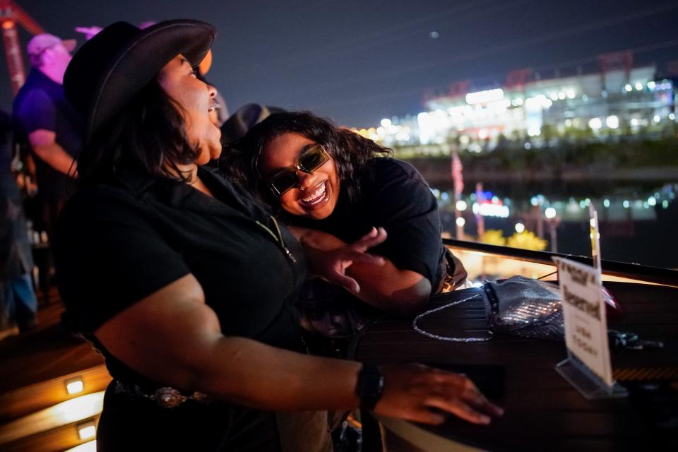 Taylor Luckey, left, and Keytoya Brooks, right, listen to music during a rooftop listening party for Beyoncé's new album "Cowboy Carter" at Acme Feed and Seed in Nashville, Tenn., Friday, March 29, 2024.