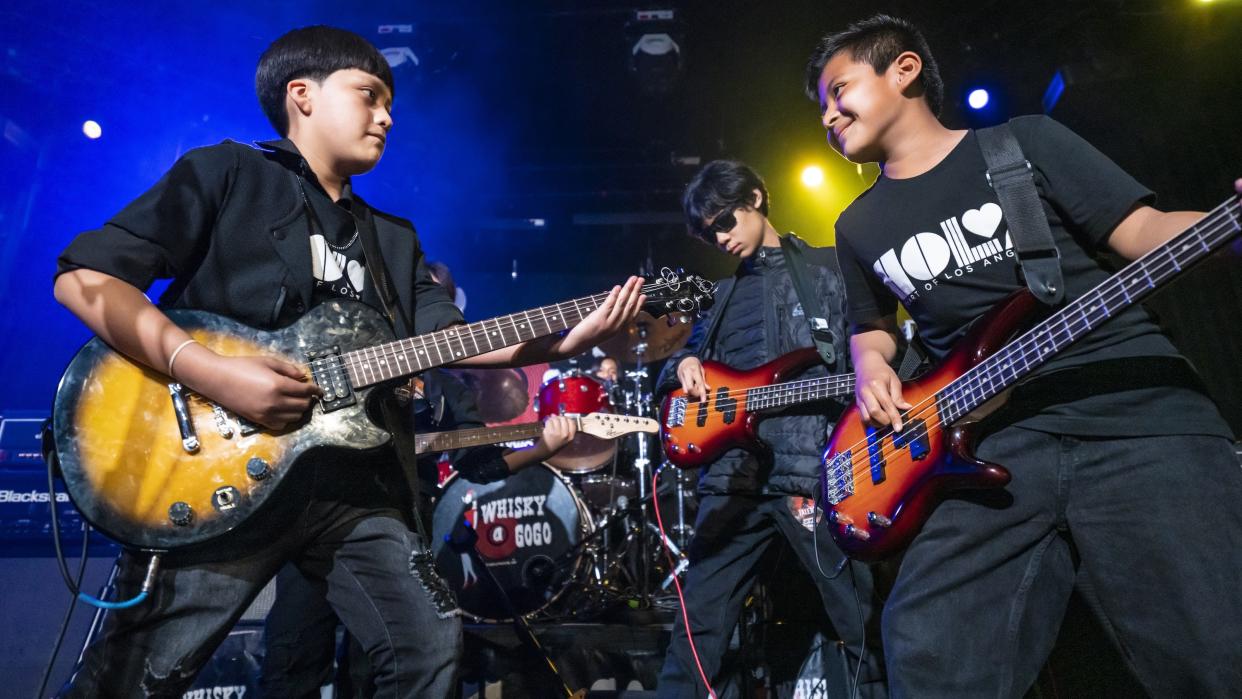  Students jam together in a rock band as part of Heart of Los Angeles' music education program. . 