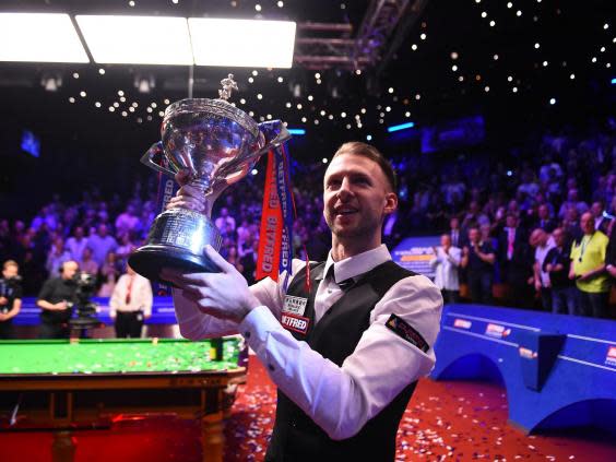 Judd Trump celebrates with the World Championship trophy (Getty)