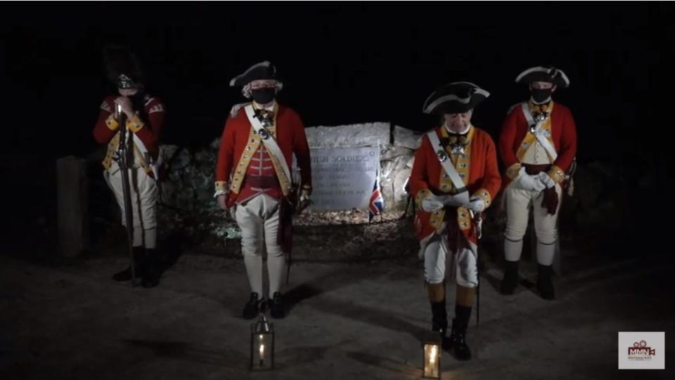 Red Coat re-enactors read off the names of the British soldiers who died during the American Revolution.