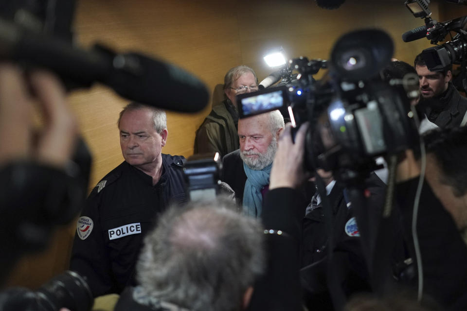 Former French priest Bernard Preynat, center, arrives at the Lyon court house, central France, Monday Jan.13, 2020. Bernard Preynat, is accused of sexually abusing some 75 Boy Scouts went on trial Monday _ but the proceedings were delayed until Tuesday because of a strike by lawyers. Preynat admitted in the 1990s to abusing boys, but was only removed from the priesthood last year. (AP Photo/Laurent Cipriani)