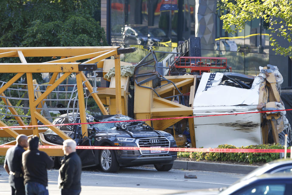 Emergency crews work at the scene of a construction crane collapse where several people were killed and others were injured Saturday, April 27, 2019, in the South Lake Union neighborhood of Seattle. The crane collapsed near the intersection of Mercer Street and Fairview Avenue pinning cars underneath it near Interstate 5. (AP Photo/Joe Nicholson)