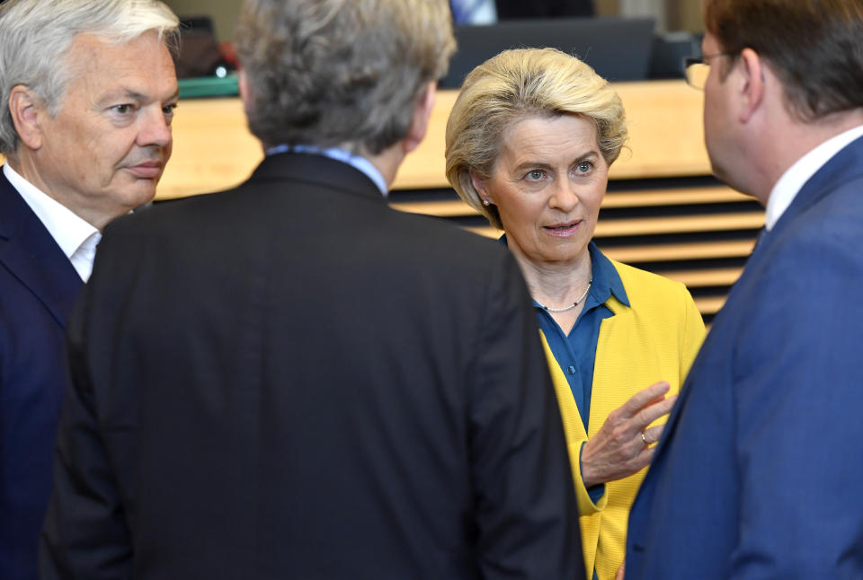 European Commission President Ursula von der Leyen, second right, speaks with from left, European Commissioner for Justice Didier Reynders, European Commissioner for Internal Market Thierry Breton and European Commissioner for Neighborhood and Enlargement Oliver Varhelyi during a meeting of the College of Commissioners at EU headquarters in Brussels, Friday, June 17, 2022. Ukraine's request to join the European Union may advance Friday with a recommendation from the EU's executive arm that the war-torn country deserves to become a candidate for membership in the 27-nation bloc. (AP Photo/Geert Vanden Wijngaert)