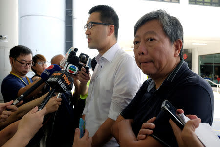 FILE PHOTO: Pro-democracy lawmaker Lam Cheuk-ting (L) and Democratic Party member Lee Cheuk-yan meet journalists outside a hospital in Hong Kong, China August 11, 2017. REUTERS/Bobby Yip/File Photo