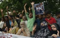 Relatives carry photographs of Pakistani national Zulfiqar Ali, who was sentenced to death in 2005 for heroin possession in Indonesia, during a protest in Lahore on July 28, 2016