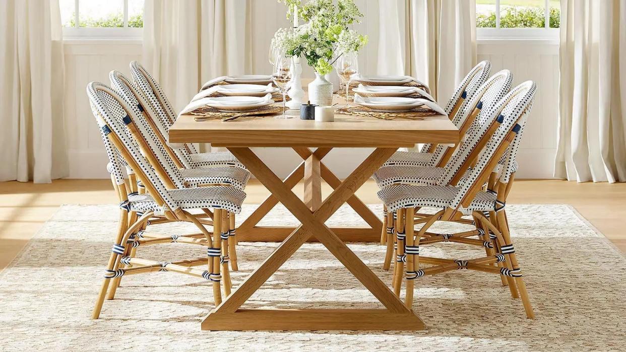 a dining room table with chairs and a chandelier