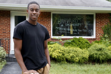 Fadhal Moore, a 2015 graduate of Harvard University, is celebrated by a front window painted with his accomplishment at his family's home in Washington June 3, 2015. REUTERS/Jonathan Ernst