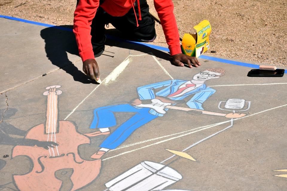 Jordan Simmons created a chalk-drawing take on Buddy Holly during the First Friday Art Trail in May at the Buddy Holly Center in Lubbock.