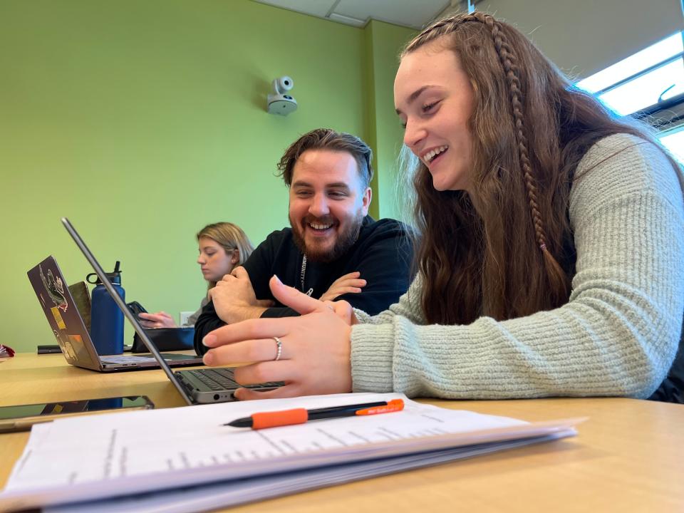 Instructor Jay Dubberly talks college freshman and high school senior, Aunika Higbee, through her research paper in a Dimensions of Self Society class on Nov. 2, 2023, at Community College of Vermont. Dubberly was helping Higbee, an Early College student, focus interview questions she was planning to ask.