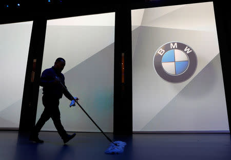 A worker sweeps up the floor in preparation for a BMW press conference at the Los Angeles Auto Show in Los Angeles, California, U.S. November 28, 2018. REUTERS/Mike Blake