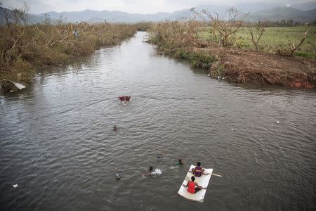 Children swim in the Rakiraki River among the Cylone Winston-damaged landscape in Fiji, February 24, 2016 in this image supplied by UNICEF. REUTERS/UNICEF-Sokhin/Handout via Reuters