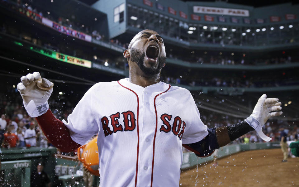 Boston Red Sox’s Eduardo Nunez reacts as he is doused with water after reaching first on a throwing error, driving in J.D. Martinez and breaking a 7-7 tie, during the bottom of the ninth inning of a baseball game against the Miami Marlins at Fenway Park in Boston, Tuesday, Aug. 28, 2018. (AP Photo)