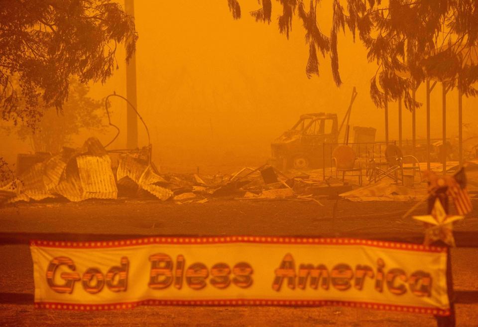 A patriotic banner is seen in front of a burned out property during the Dixie fire in Greenville, California on Aug. 6, 2021.