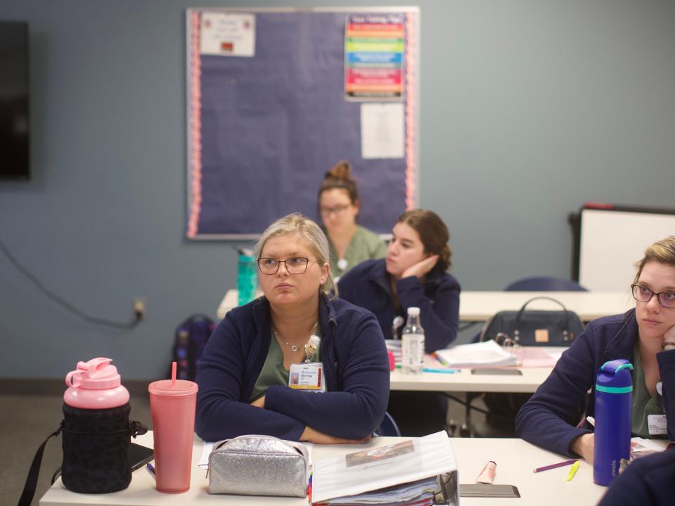 Students in the top-rated Tri-Rivers Career Center LPN - RN program listen and take notes as instructor Darian Curren teaches.