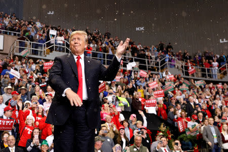 FILE PHOTO: U.S. President Donald Trump gestures as artificial snow falls during his address to supporters at a Make America Great Again rally in Biloxi, Mississippi, U.S., November 26, 2018. REUTERS/Kevin Lamarque/File Photo