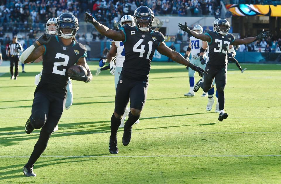 Jaguars linebacker Josh Allen (41) celebrates Rayshawn Jenkins' interception and touchdown to win Sunday's game against Dallas.