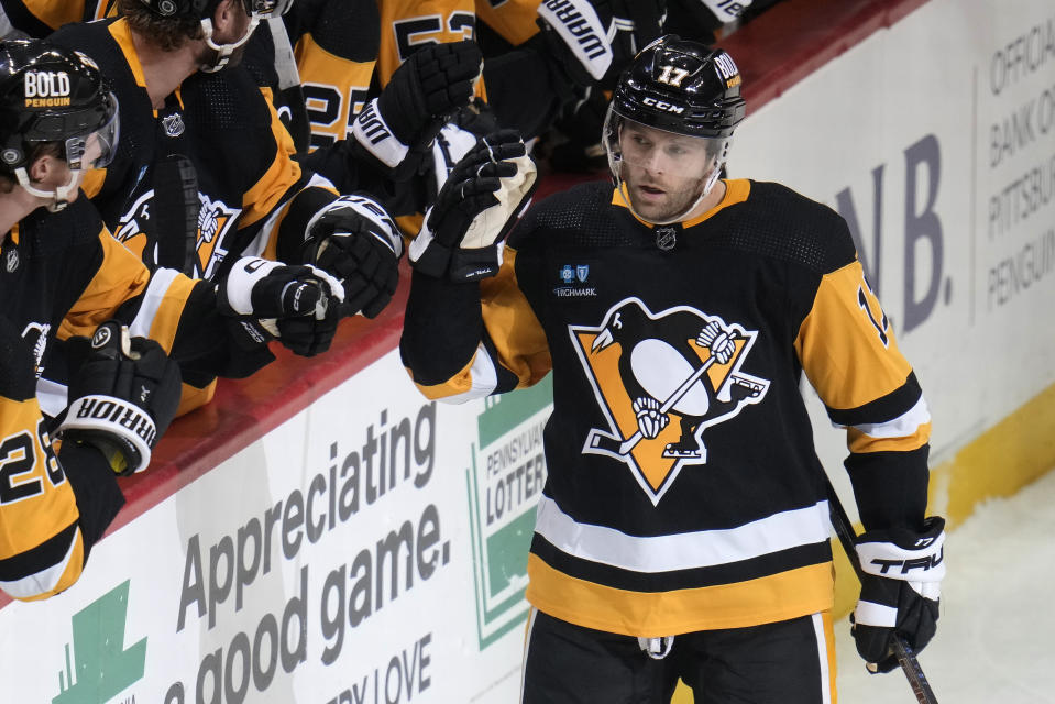 Pittsburgh Penguins' Bryan Rust (17) returns to the bench after scoring during the first period of the team's NHL hockey game against the St. Louis Blues in Pittsburgh, Saturday, Dec. 3, 2022. (AP Photo/Gene J. Puskar)