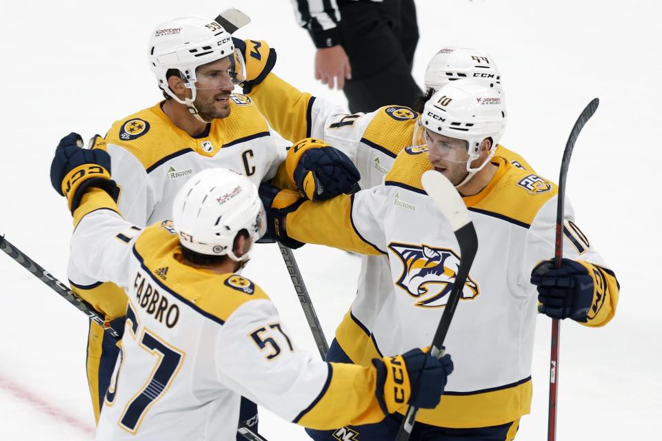Nashville Predators' Colton Sissons (10) celebrates his goal with Dante Fabbro (57), Roman Josi (59) and Kiefer Sherwood (44) during the second period of an NHL hockey game against the Boston Bruins, Saturday, Oct. 14, 2023, in Boston. (AP Photo/Michael Dwyer)