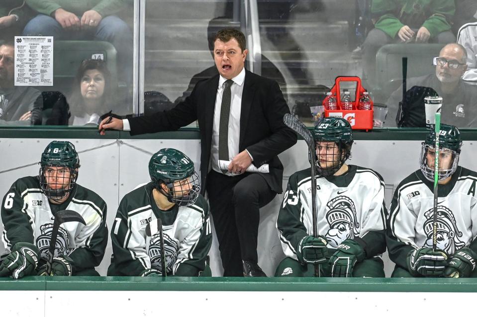 Michigan State's head coach Adam Nightingale, center, calls out to players during the second period in the game against Notre Dame on Friday, Dec. 8, 2023, at Munn Arena in East Lansing.