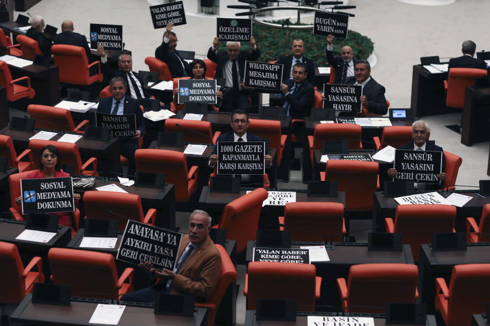 FILE - Lawmakers from the main opposition Republican People's Party hold up placards in protest at the parliament, in Ankara, Turkey, Tuesday, Oct. 11, 2022. (AP Photo/Burhan Ozbilici, File)