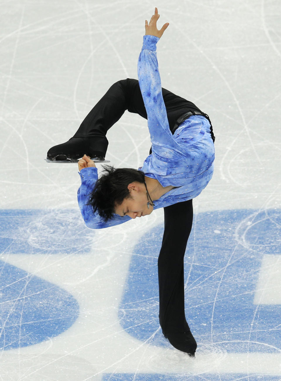 Yuzuru Hanyu of Japan competes in the men's team short program figure skating competition at the Iceberg Skating Palace during the 2014 Winter Olympics, Thursday, Feb. 6, 2014, in Sochi, Russia. (AP Photo/Vadim Ghirda)