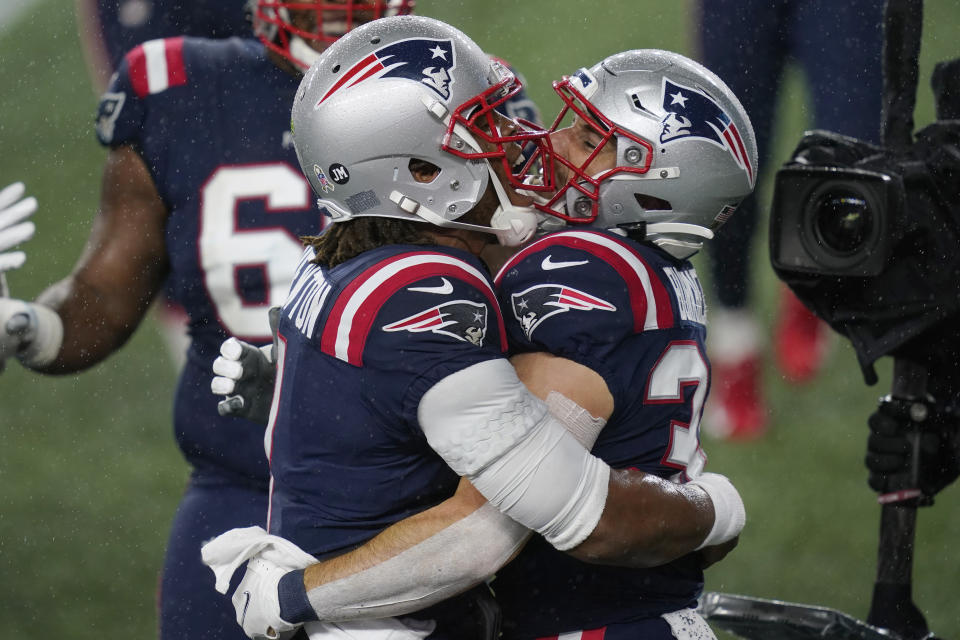 New England Patriots quarterback Cam Newton, left, celebrates with running back Rex Burkhead. (AP Photo/Elise Amendola)