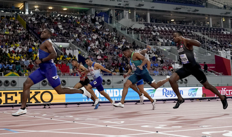Christian Coleman, of the United States, crosses the line ahead of Aaron Brown, of Canada, and Adam Gemili, of Great Britain, in a men's 100 meter semifinal at the World Athletics Championships in Doha, Qatar, Saturday, Sept. 28, 2019. (AP Photo/David J. Phillip)