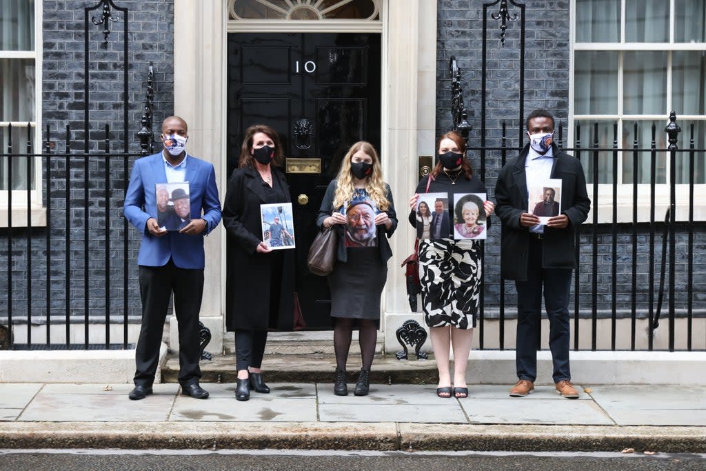 Members of the Covid-19 Bereaved Families for Justice group holding photos of loved ones outside 10 Downing Street, London, after their private meeting with Boris Johnson (James Manning/PA) (PA Wire)