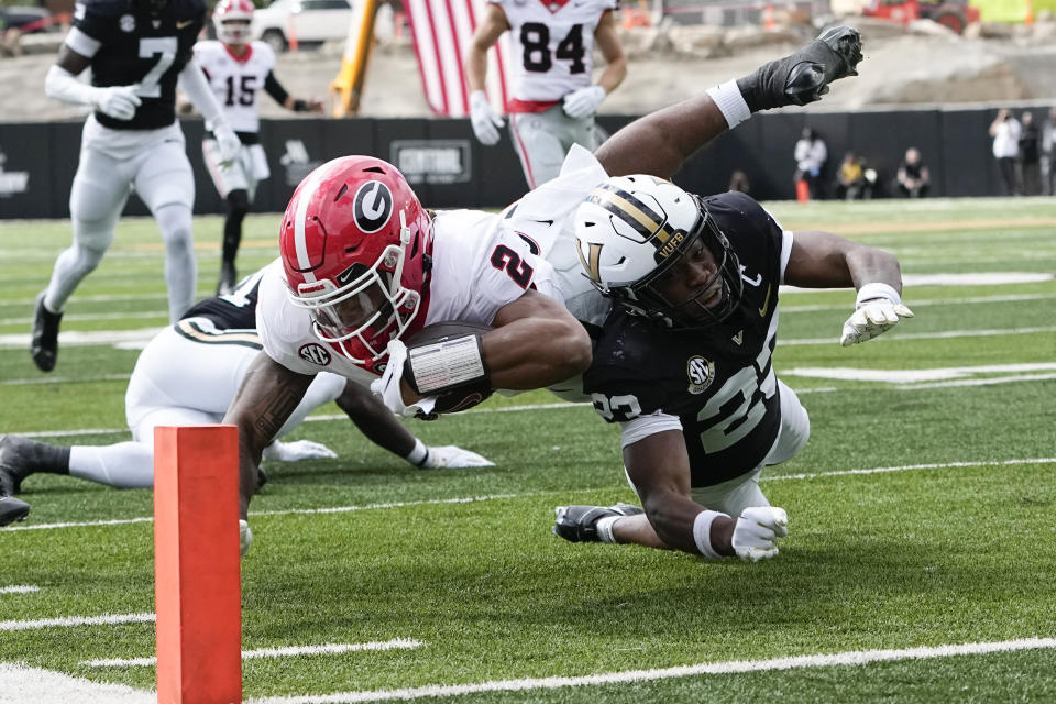 Georgia running back Kendall Milton (2) is tackled short of the goal line by Vanderbilt defensive back Jaylen Mahoney, right, durinig the first half of an NCAA college football game Saturday, Oct. 14, 2023, in Nashville, Tenn. (AP Photo/George Walker IV)