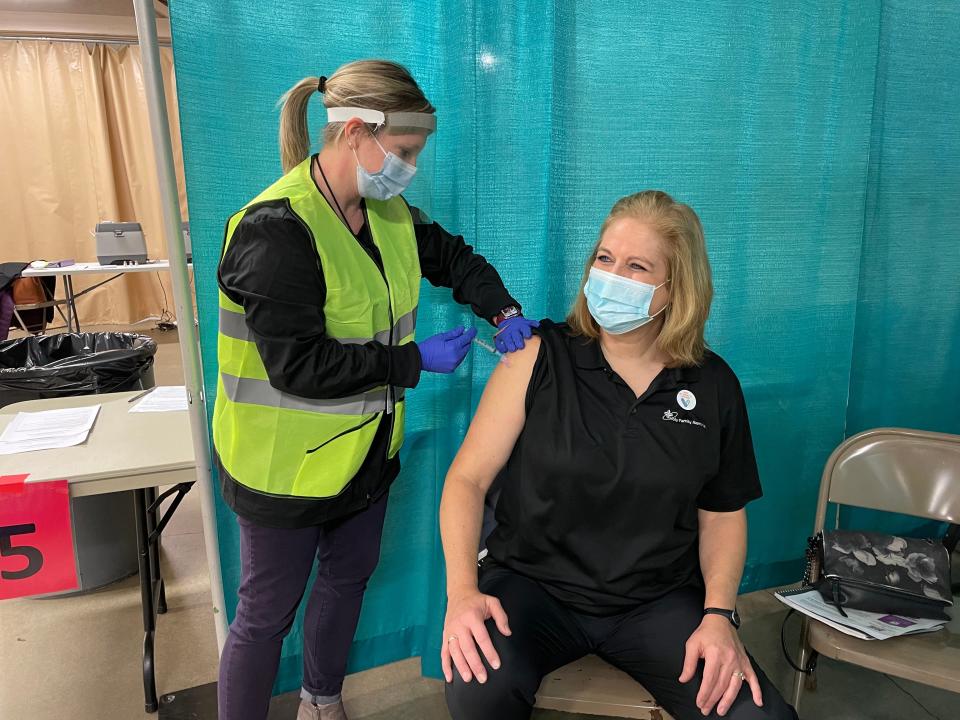 A person receives the COVID-19 vaccine at the Manitowoc County Expo.