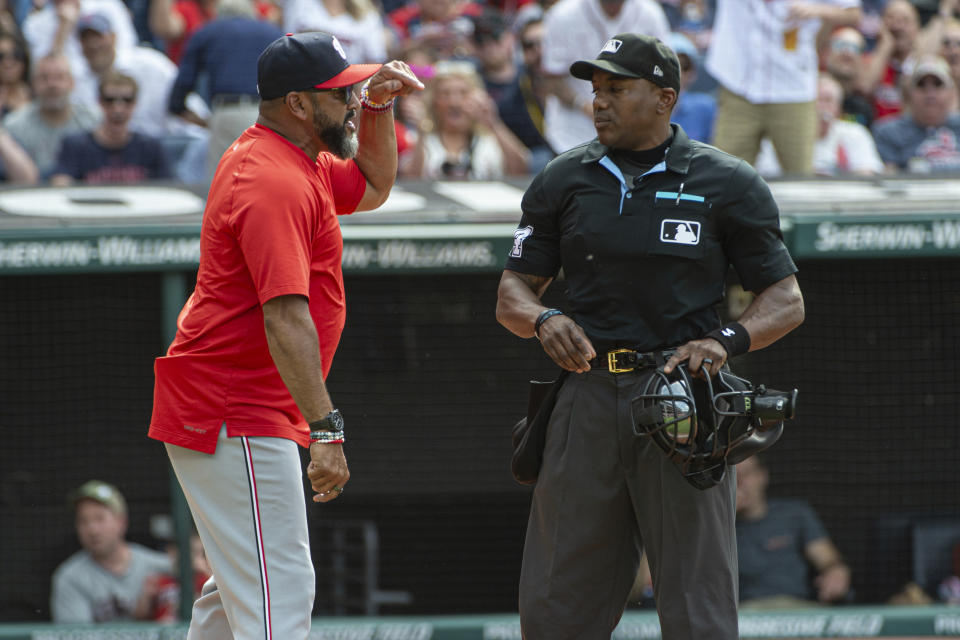 Washington Nationals manager Dave Martinez, left, argues with umpire Malachi Moore, right, after his ejection by Moore during the third inning of a baseball game against the Cleveland Guardians in Cleveland, Saturday, June 1, 2024. (AP Photo/Phil Long)