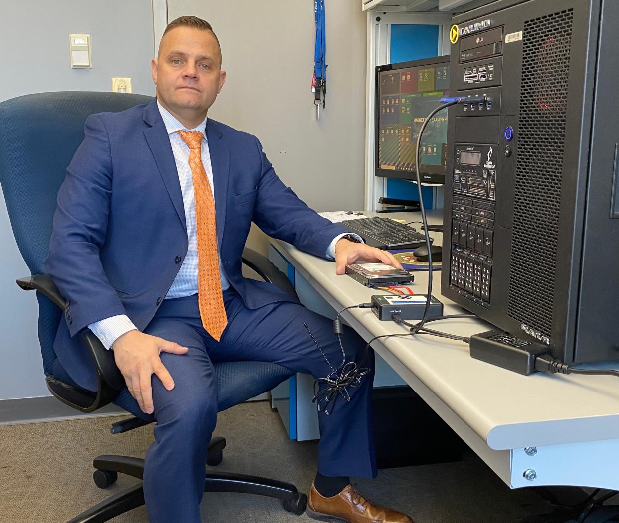 Providence police Detective Sgt. Jonathan Primiano heads up the Providence Police Department's Digital Intelligence Unit. The forensics equipment in his office helps investigators scrape valuable data from computer hard drives.