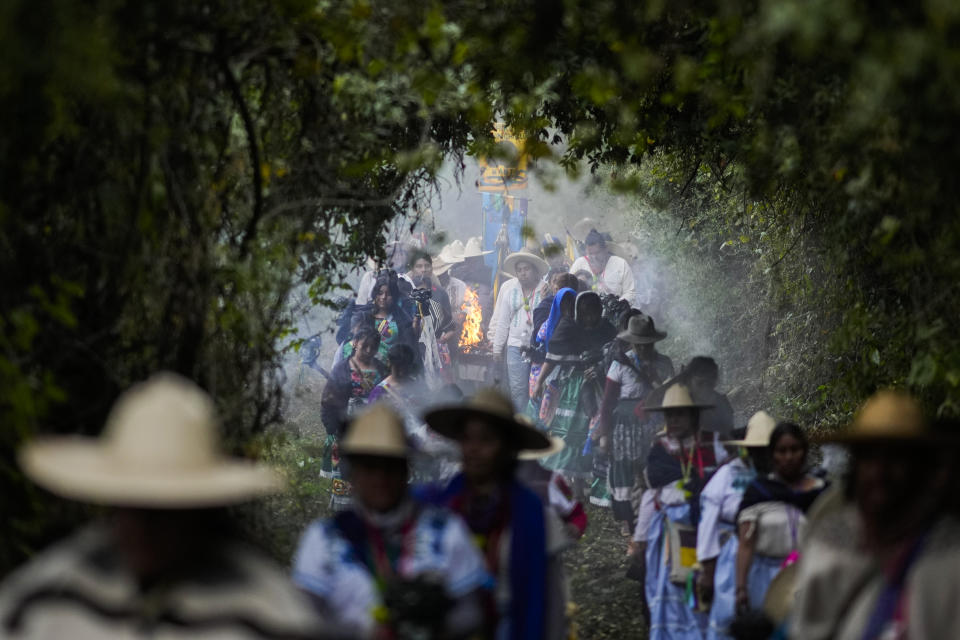 Purepechas Indigenous people carry a flame through the mountains, from Erongaricuaro where residents kept the flame alive for one year, to the residents of Ocumicho in Michoacan state, Mexico, Wednesday, Jan. 31, 2024. A new flame will be lit in Ocumicho at the “New Fire” ceremony on Feb. 2 to mark the new year, after extinguishing the old fire on Feb. 1 which is considered an orphan day that belongs to no month and is used for mourning and renewal. (AP Photo/Eduardo Verdugo)