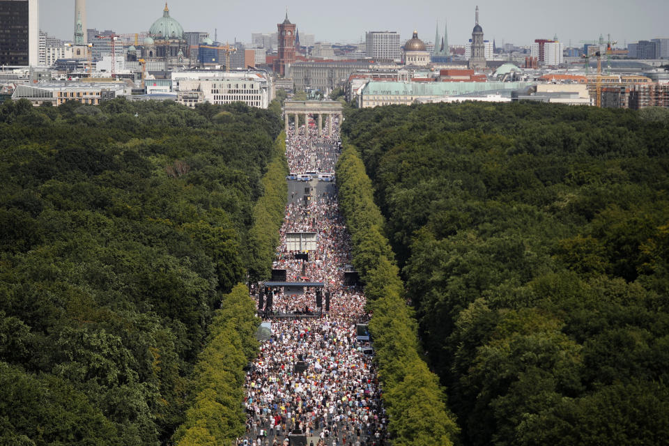 People gather at the Brandenburg gate for a demonstration with the slogan ‚The end of the pandemic - freedom day' - against coronavirus restrictions in Berlin, Germany, Saturday, Aug. 1, 2020. It comes amid increasing concern about an upturn in infections in Germany. (AP Photo/Markus Schreiber)