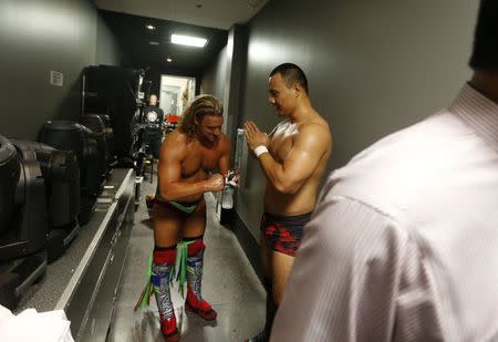 WWE wrestler Bin Wang (R) of China bows to opponent Wesley Blake backstage after their match during a taping of the WWE's NXT show at Full Sail University in Winter Park, Florida, November 30, 2016. REUTERS/Scott Audette