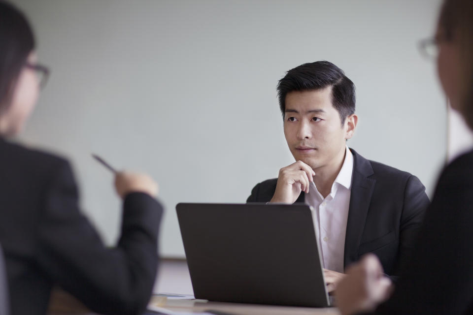 Businessman looking across table in office meeting