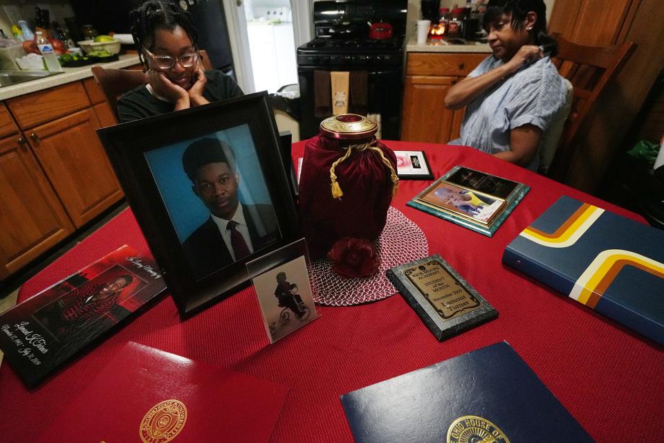 July 8, 2022; Reynoldsburg, Ohio;The Turner family lost their son, Lamont Turner, pictured, to suicide in 2019 after he was sexually abused by his doctor. They displayed some of his possessions and his urn, center. At left is his sister, Shawana, and at right is his mother, Andrea. Fred Squillante-The Columbus Dispatch