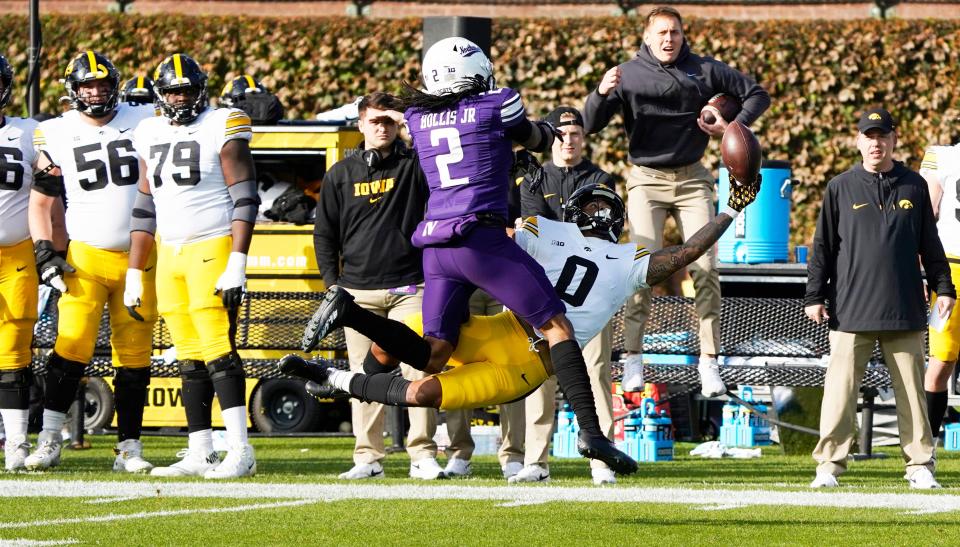 Nov 4, 2023; Chicago, Illinois, USA; Northwestern Wildcats defensive back Garnett Hollis Jr. (2) defends Iowa Hawkeyes wide receiver Diante Vines (0) during the first half at Wrigley Field. Mandatory Credit: David Banks-USA TODAY Sports