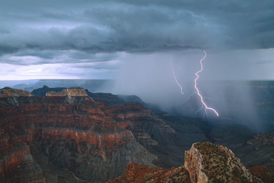 Lightning arcs into Grand Canyon near Point Sublime on the North Rim.