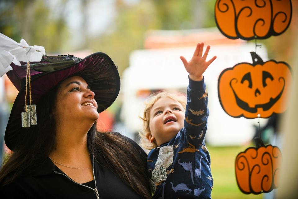 Carolina Simon and her son, David, enjoy the decorations hanging from a tent at the CB Cares 2021 Pumpkinfest event Saturday, Oct, 23, 2021, at Bucks County Tile Works in Doylestown. The event is canceled this year after a rift between CB Cares and Central Bucks but CB Cares President Phil Ehlinger said Pumpkinfest will resume next year.