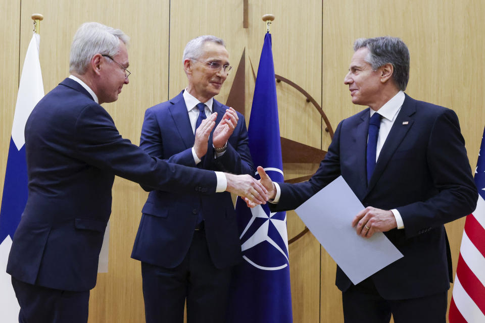 Finnish Foreign Minister Pekka Haavisto, left, shakes hands with United States Secretary of State Antony Blinken, right, after handing over his nation's accession document during a meeting of NATO foreign ministers at NATO headquarters in Brussels, Tuesday, April 4, 2023. Finland joined the NATO military alliance on Tuesday, dealing a major blow to Russia with a historic realignment of the continent triggered by Moscow's invasion of Ukraine. (Johanna Geron, Pool Photo via AP)