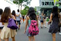 Unexpected colors can liven up any outfit. "That's me in the middle of my best friend and sister in Singapore (my best friend lives there). I love this cute pink backpack."